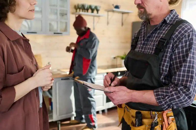 Plumber listening customer concerns before beginning the work.