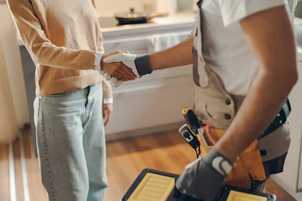 Angelo shaking hands with a customer in the kitchen